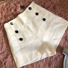 New! White High Waist Shorts With Black Buttons. Side Zipper. Extra Buttons Attached. Never Worn. Needs To Be Steamed But Otherwise Perfect Condition. Trendy White Shorts For Workwear, White High Waist Shorts With Buttons, Fitted White Shorts With Buttons, Trendy Cream Short Bottoms, White Fitted Buttoned Shorts, High Waist Cream Shorts For Work, High-waisted Cream Shorts For Work, Trendy Cream Shorts For Day Out, Chic Buttoned Shorts For Day Out