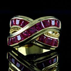 a gold ring with pink stones in it