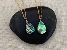 "Vibrant abalone shell pendants on a custom chain of your choice. Choose your favorite pendant, you will receive exact one pictured. Stone measures 14mm x 10mm. Choose your desired necklace length from the drop down menu. A 2-inch extender chain can be added upon request. This extender chain is 2\" of a larger link that allows you to adjust where the necklace lays depending on what you're wearing. Great option if you're buying a gift!" Bohemian Shell Charm Necklace As Gift, Pendant Shell Necklace With Lobster Clasp As Gift, Elegant Abalone Shell Necklace As Gift, Elegant Abalone Shell Necklace For Gift, Gift Shell Necklace With Lobster Clasp, Handmade Teardrop Abalone Shell Jewelry, Handmade Shell-shaped Necklace For Gift, Spiritual Shell Necklace As Gift, Handmade Shell Pendant Necklace For Gift