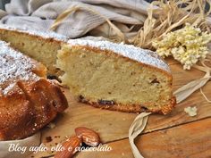 a piece of cake sitting on top of a wooden table next to a slice of bread