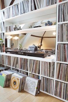 a record player is in the middle of a room full of records