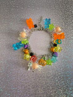 If you love to wear cute halloween stuff, then this candy halloween charm bracelet is the perfect wear! With gummy bears, candy, pumpkins, lollipops, and so much more this bracelet will be the highlight of the halloween season✨.  Check out our charm bracelets section for more unique designs that are OOAK! Product info: *Made with stainless steel materials only (except for metal charms that are vintage metal) *Adjustable, reaches up to 6.5 inches *Charms vary from acrylic, metal, and plastic  If you have any questions, please don't hesitate to ask! We are friendly:) Visit our official website: www.yeetincolorboutique.com and follow us on Instagram: @yeetincolorboutique Multicolor Charms Party Bracelet, Cute Orange Jewelry For Party, Cute Orange Party Jewelry, Playful Orange Dangle Jewelry, Playful Orange Party Jewelry, Fun Orange Jewelry For Halloween, Fun Orange Halloween Jewelry, Cute Multicolor Charm Bracelet For Parties, Party Charm Bracelet With Dangle Charms