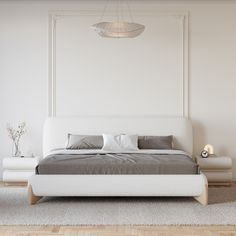 a white bed with pillows and blankets in a room