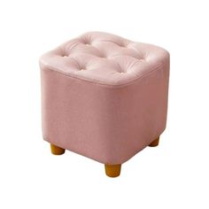 a small pink ottoman with wooden legs