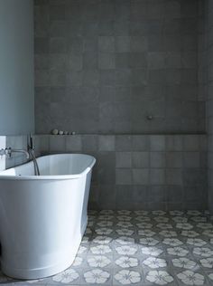 a white bath tub sitting inside of a bathroom