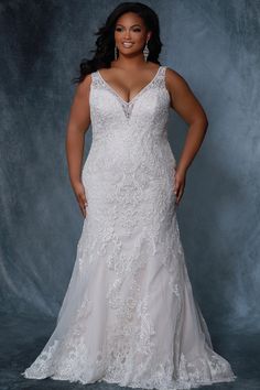 a woman in a white wedding dress posing for a photo with her hands on her hips