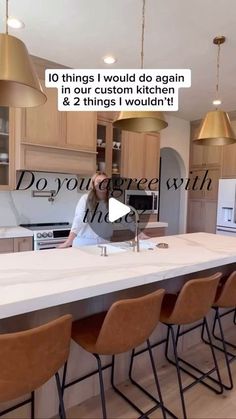 a woman sitting at a kitchen island with lots of chairs