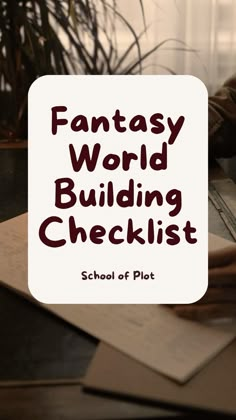 the words fantasy world building checklist written in red on top of a desk next to an open laptop computer