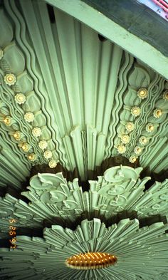 the ceiling is decorated with gold and white flowers