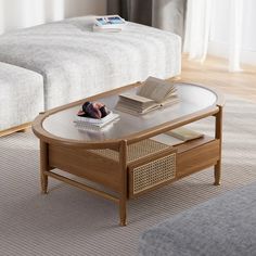 a coffee table with books on it in a living room