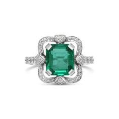 Metal: 14K White Gold Gemstones: 3.10 Cts. Emerald 0.35 Cts. Diamond Luxury Emerald Ring With Halo Diamond Design, Luxury Heart Cut Emerald Ring For Formal Occasions, Big Emerald Ring, Classic Diamond Gemstone With Center Stone, Emerald Ring With Center Stone In 14k White Gold, Classic Platinum Gemstones With Halo Setting, Luxury Emerald Ring With Baguette Cut And Accent Stones, Elegant Gia Certified Emerald Cluster Ring, Gia Certified Elegant Emerald Gemstones