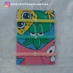 the spongebob notebook is decorated with colorful paper and bead trimmings