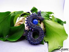 Original pendant depicting a dragon guarding an egg. Made with great care and precision from Toho, Miyuki and Czech FP beads, the dragon egg is an agate ball. The whole thing is hung on a braided strap 48 cm / 18.9inch long Dragon height 8cm / 3.14inch dragon width 4 cm / 1.57inch I can make a dragon in other colors - just write to me:) Unique Pendant Beads As Gift, Fantasy Beaded Jewelry As Gift, Fantasy Blue Jewelry For Jewelry Making, Blue Fantasy Jewelry For Jewelry Making, Handmade Blue Fantasy Jewelry, Blue Fantasy Jewelry For Gifts, Handmade Blue Amulet Beads, Blue Fantasy Jewelry For Gift, Blue Beaded Gems And Cabochons For Gift