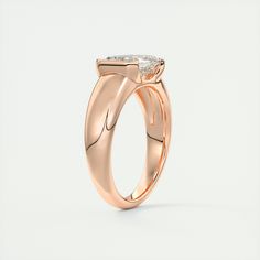 a rose gold ring with a single diamond in the center