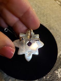 "Super HIGH QUALITY Everything! All Sterling Silver in a flower shape; Petals are all made of inlaid ABALONE (specifically from New Zealand and called Paua Shell - very intense colors); Center is a 7x7mm Sugarloaf cut AMETHYST. **THIS PIECE IS BOTH A PENDANT AND A PIN OR BROOCH** Measures 1.25\" each direction. I am including an 18\" Sterling Silver chain too. Hallmarked SAJEN 925 By the renowned designers RICHARD & MARIANNA JACOBS, the OFFERINGS line by SAJEN. Made in Bali. Contact me with Amethyst Brooch For Anniversary, Amethyst Brooch Jewelry For Anniversary, Amethyst Large Pendant Jewelry Gift, Spiritual Silver Jewelry Brooch, Spiritual Silver Brooch, Flower Pendant Brooch Jewelry Gift, Flower Shaped Brooch Jewelry As Gift, Purple Brooch Jewelry Gift, Purple Sterling Silver Flower-shaped Jewelry