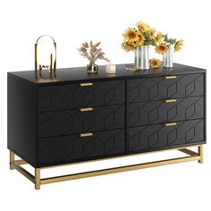 a black and gold dresser with sunflowers in vases next to the drawers