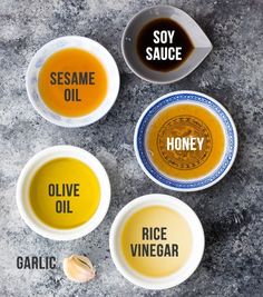 three bowls filled with different types of sauces on top of a stone countertop