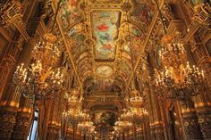 an ornate room with chandeliers and paintings on the ceiling