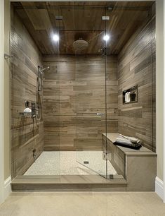 a walk in shower sitting next to a wooden wall