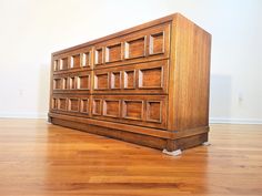 a large wooden dresser sitting on top of a hard wood floor