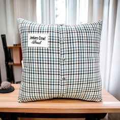 a pillow sitting on top of a wooden table