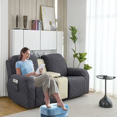 a woman sitting in a chair reading a book