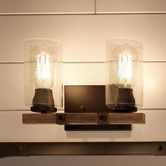 two light fixtures mounted on a wall in a bathroom