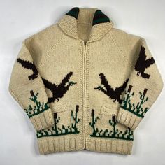 a sweater with an image of birds on the front and green leaves on the back