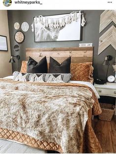 a large bed sitting in a bedroom next to a wooden headboard