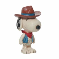 a ceramic figurine of a dog wearing a cowboy hat