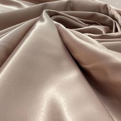 Introducing our gorgeous Satin Bridal Fabric - perfect for creating an exquisite wedding dress, evening gown, dance costume, or any other special occasion! Our stunning selection of 100% Polyester lace is the epitome of couture, designed to make your project extra special. Whether you’re looking for lace fabric for a quinceanera dress, an evening dress, or a dance costume, our selection of 17 different colors range from classic whites and ivories to bright and bold colors. Not only does this bri Elegant Stretch Wedding Gown, Formal Beige Satin Gown, Elegant Blush Wedding Gown, Beige Satin Wedding Gown, Elegant Gown With Satin Finish For Debutante Ball, Quinceanera Crown, Wedding Dress Evening, Satin Wedding Gown, For Wedding Dresses