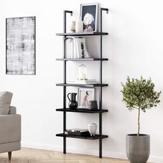 a living room with a couch, chair and book shelf on the wall in front of it