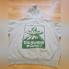 Take Your Love For The Legend Of Zelda To The Next Level With This Rare Nintendo Zelda Link Hoodie Shirt. The Hoodie Features A Gray Color With A Pullover Style, Long Sleeves, And A Character Print Of Link From The Game. This Hoodie Is Perfect For Both Men And Women Who Are Fans Of The Game And Want To Show Off Their Love For It. Made In Japan, This Hoodie Comes In A Regular Size Type And Is A Great Addition To Your Activewear Collection. Get Your Hands On This Limited Edition Hoodie And Make A Zelda Shirt, The Legend Of Zelda, Shirt Long Sleeve, Legend Of Zelda, Pullover Styling, Made In Japan, Hoodie Shirt, Nintendo, Gray Color