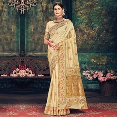 Beige colored festive wear saree. This saree is made from banarasi silk fabric which is highlighted with beautiful woven work as shown. Comes along unstitched banarasi silk blouse piece which you can customise as per your design/style. Occasion - You can wear this saree for festive, special occasions, ideal for any fashionista. Style it up - Look glamorous in this traditional saree by (SANGAM PRINTS) Pair this saree with beautiful clutch to complete the look!!Note:- The actual product may differ Tussar Silk Meenakari Saree For Eid, Meenakari Tussar Silk Saree For Eid, Elegant Meenakari Paithani Silk Pre-draped Saree, Festival Meenakari Raw Silk Saree, Meenakari Raw Silk Saree For Festivals, Gold Embroidered Banarasi Silk Saree, Elegant Banarasi Silk Pre-draped Saree With Meenakari, Elegant Embroidered Paithani Silk Saree, Navratri Tussar Silk Saree With Meenakari