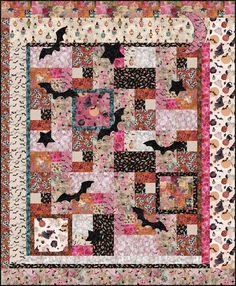 a quilt with bats and flowers on it