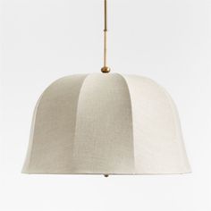 a white lamp hanging from a ceiling with a light fixture on it's side