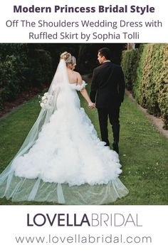 a bride and groom walking through the grass