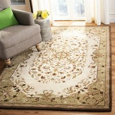 a living room area with a couch, chair and rug