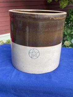 a brown and white pot sitting on top of a blue table cloth