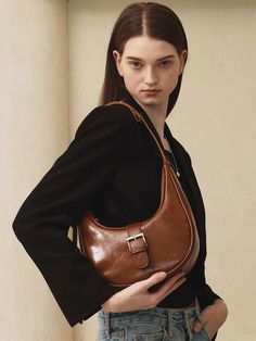 Mur always thinks about the value of ‘our’ and focuses on how it can be incorporated into your daily life.- Bag with curve and buckle decoration- Natural crack leather with oily gloss - Casual and cute mood design- Can be worn in two ways: shoulder or cross Brown Bags With Buckle Closure For Everyday, Brown Everyday Bag With Buckle Closure, Elegant Everyday Shoulder Bag With Buckle Closure, Trendy Brown Bags With Buckle Closure, Everyday Saddle Bag With Hasp Closure, Trendy Brown Shoulder Bag With Buckle Closure, Chic Leather Saddle Bag With Hasp Closure, Chic Business Shoulder Bag With Buckle Closure, Leather Shoulder Bag With Hinge Closure