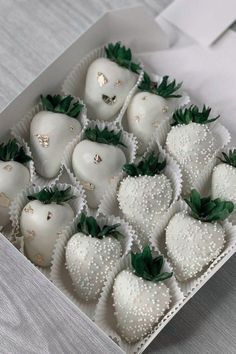 a box filled with white chocolate covered strawberries