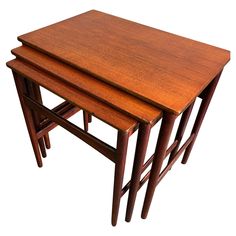 three wooden nesting tables sitting on top of each other