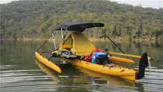 a yellow kayak sitting on top of a body of water