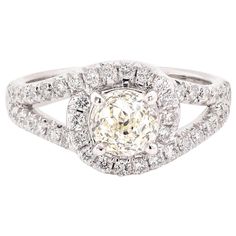 a diamond ring with two rows of diamonds on the band and an oval center stone