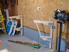 a camera is set up in front of a wall with plywood boards and other construction materials