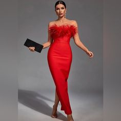 a woman in a red dress holding a black clutch