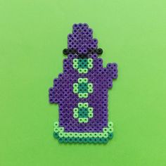 a purple and blue beaded phone case on a green background with spaceman in the middle