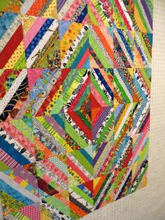 a colorful quilt hanging on the wall