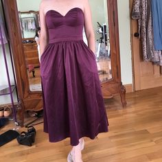 Unworn Bridesmaid Or Formal Gown. Midi Length. With Pockets!!! Beautiful Satin Fabric. Strapless. Size Xs (Fits 0-2 With Small Bust. The Zipper Is Super Sticky And Could Be Replaced For Easier Wear. I Was Not Able To Zip It Up Myself, Even Though The Dress Fits. You Can See From The Free Hanging Picture, It Does In Fact Zip, But Not Easily. Purple Strapless Evening Dress For Bridesmaid, Strapless Purple Bridesmaid Evening Dress, Fitted Midi Dress With Empire Waist For Bridesmaids, Bridesmaid Strapless A-line Dress With Ruched Bodice, Purple Dresses With Pleated Fitted Bodice, Purple A-line Bridesmaid Evening Dress, Bridesmaid Midi Dress With Sweetheart Neckline And Pleated Bodice, Purple A-line Bridesmaid Dress, Strapless Purple Bridesmaid Dress