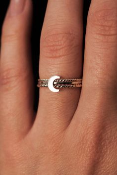 Dive into the celestial charm of our Moon Ring! The lunar-inspired design features a dainty moon on a simple, textured band - providing an adorable accent to any stack. The band measures approximately 1mm in width and features a lightly hammered finish. The moon detail measures approximately 6mm in width. This listing is for ONE SINGLE Moon Ring in STERLING SILVER metal. This ring is a great alternative to a stacking ring and is a perfect ring to mix and match with your favorite stacking rings. Every piece is organic and unique — no two Hannah Naomi pieces are exactly alike.Hand-crafted to order in our Portland, OR studio. Adjustable Moon Charm Promise Ring, Minimalist Adjustable Crescent Ring, Minimalist Crescent Moon Charm Ring, Adjustable Moon-shaped Stackable Rings For Promise, Dainty Adjustable Moon-shaped Midi Rings, Dainty Adjustable Moon Shape Midi Rings, Dainty Moon-shaped Midi Rings As Gift, Adjustable Minimalist Moon Midi Rings, Dainty Moon-shaped Midi Promise Rings